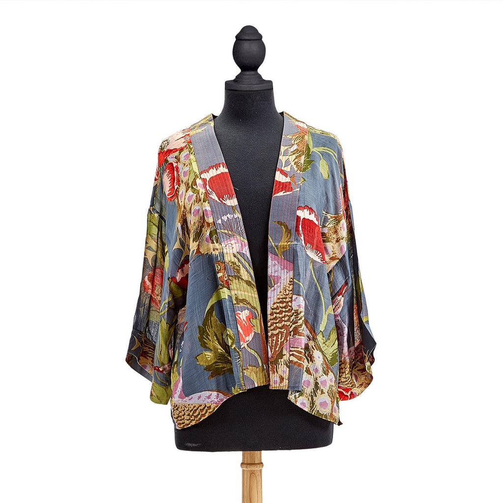 Nothing could be more representative of our local area than a print featuring poppies and peacocks! This loose-fitting kimono style jacket has ¾ length sleeves, an open front and an embroidered lapel. Made from a soft, light, sustainable modal/ cupro blend. One Size Fits Most (USA 6-16)50% Modal, 59% Cupro. Hand wash.