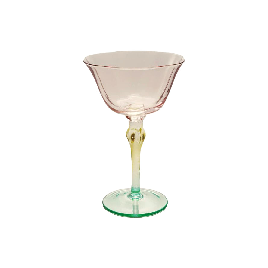Pink cocktail glass with a green stem on a white background