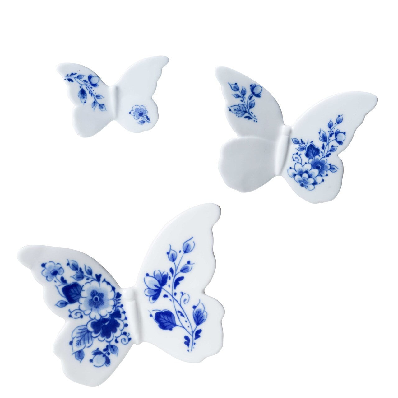 Three white porcelain wall decor butterflies with blue floral patterns on a white background