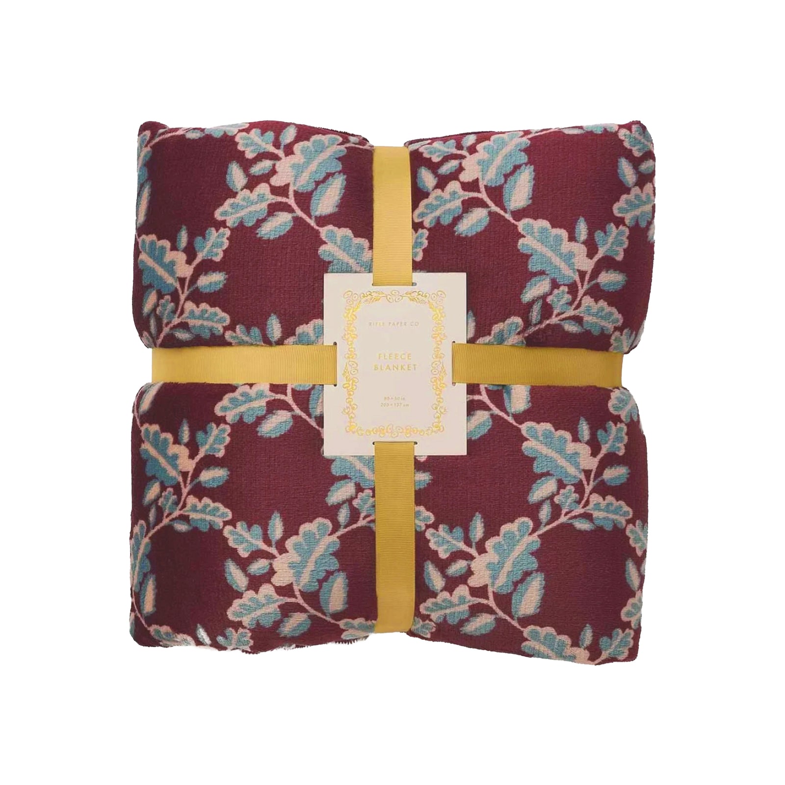 A deep burgundy fleece throw blanket with a pattern of greenish blue leaves on a white background
