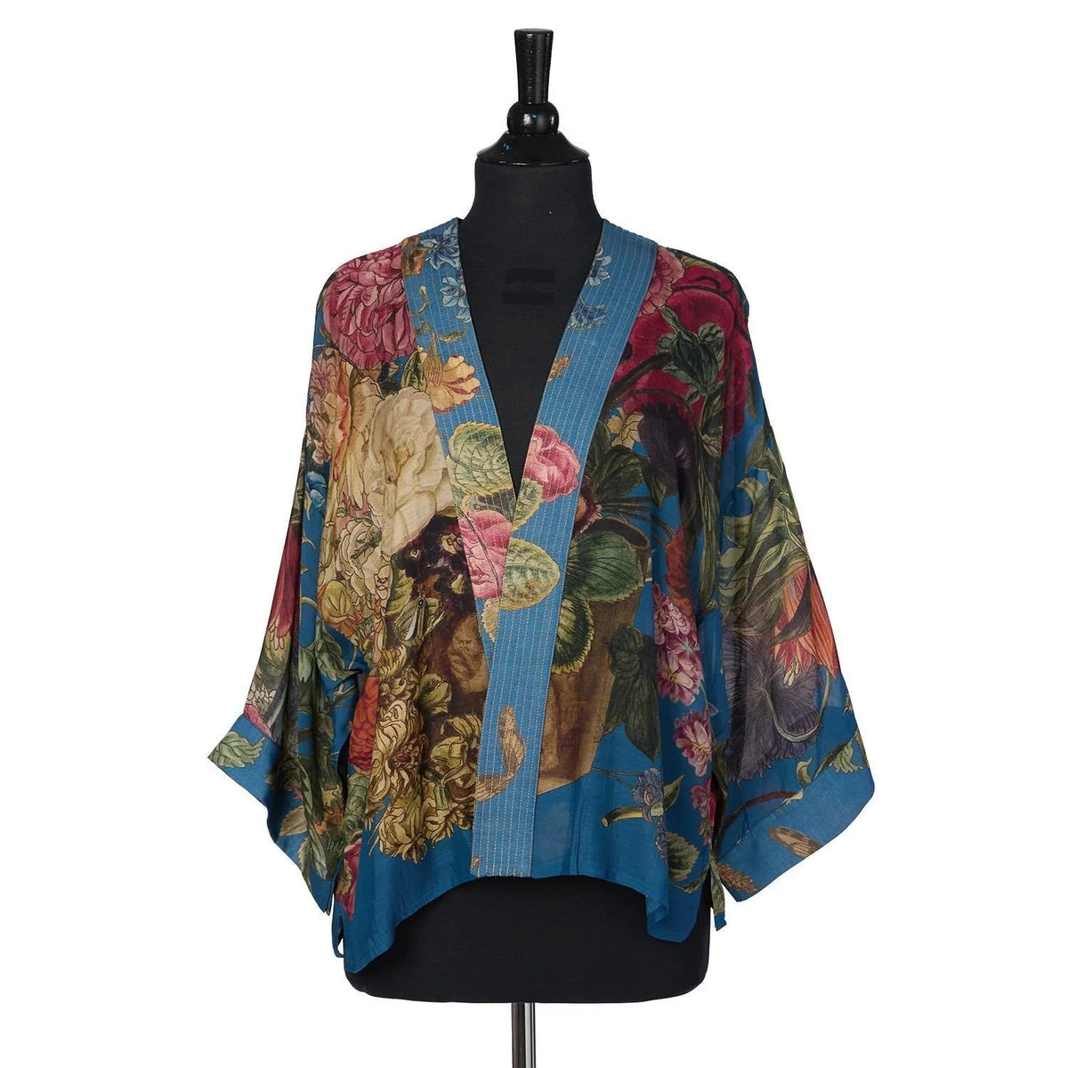 Colorful floral kimono on a mannequin against a white background