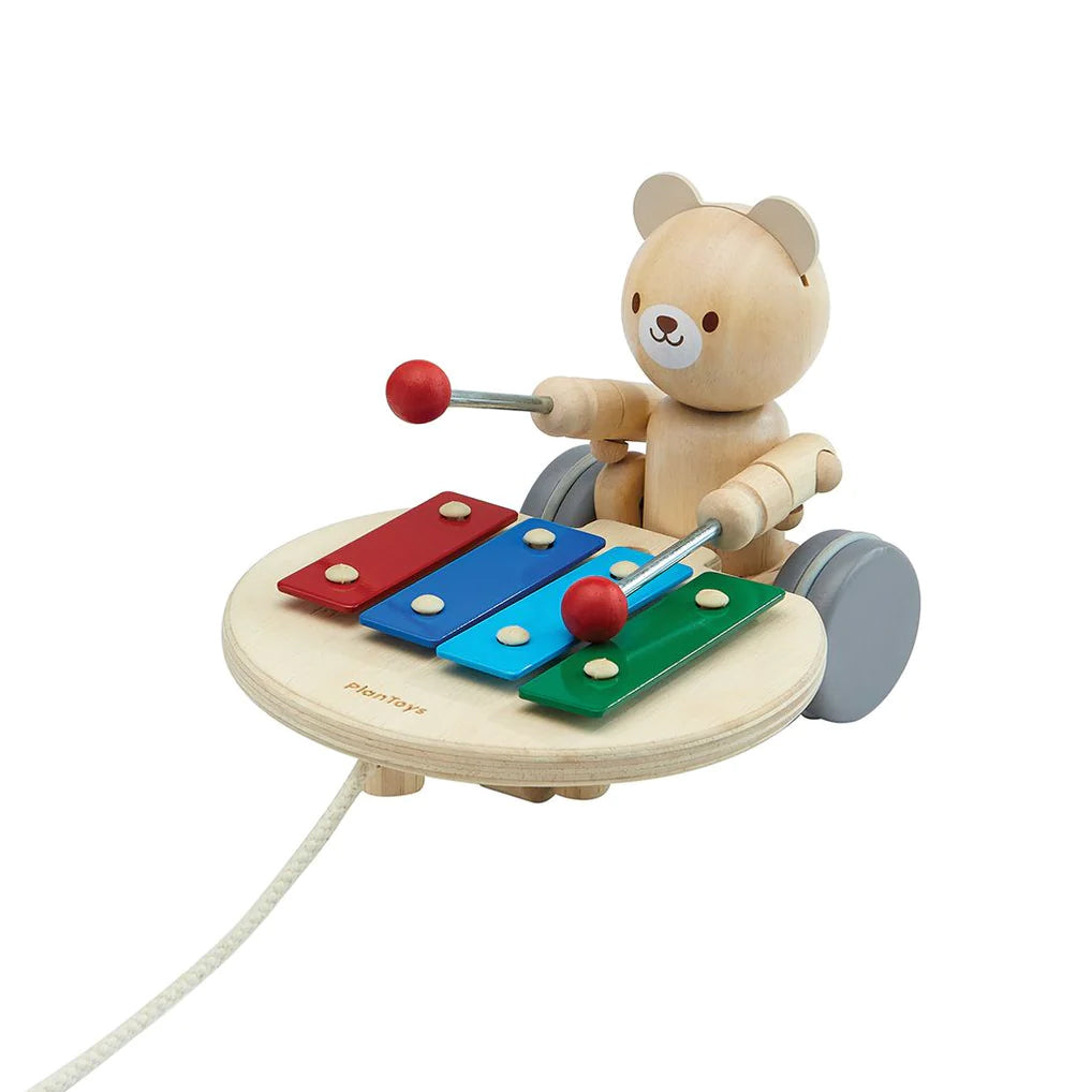 Watch as the Pull-Along Musical Bear plays music while you pull him alongside you. While in motion, the bear hits a xylophone to make unique musical sounds that stimulate toddlers learning how to walk. If the rope is pulled to the side, the bear will hit the xylophone in different keys. 6" x 5" x 7" Age: 12 months +.