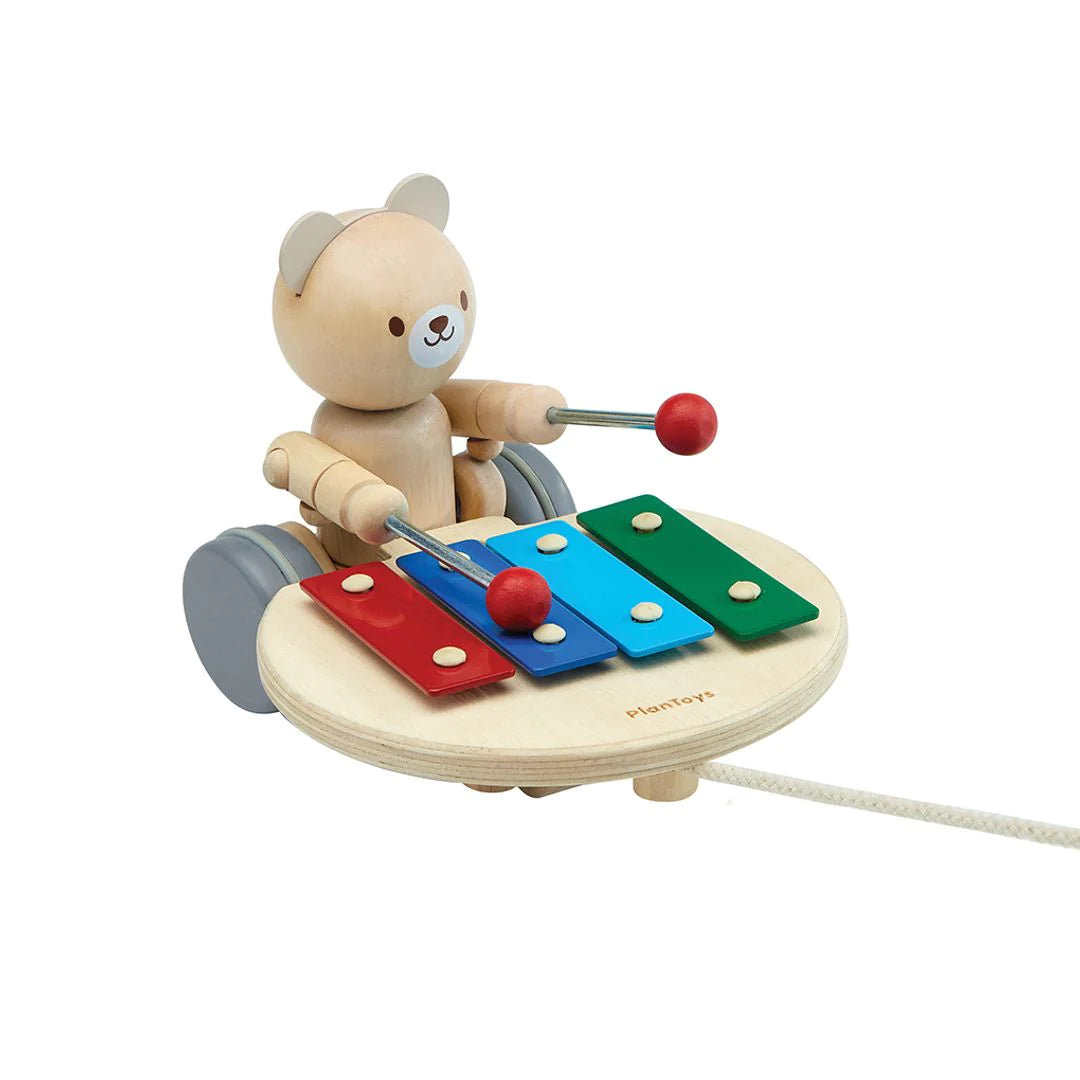 Watch as the Pull-Along Musical Bear plays music while you pull him alongside you. While in motion, the bear hits a xylophone to make unique musical sounds that stimulate toddlers learning how to walk. If the rope is pulled to the side, the bear will hit the xylophone in different keys. 6" x 5" x 7" Age: 12 months +.