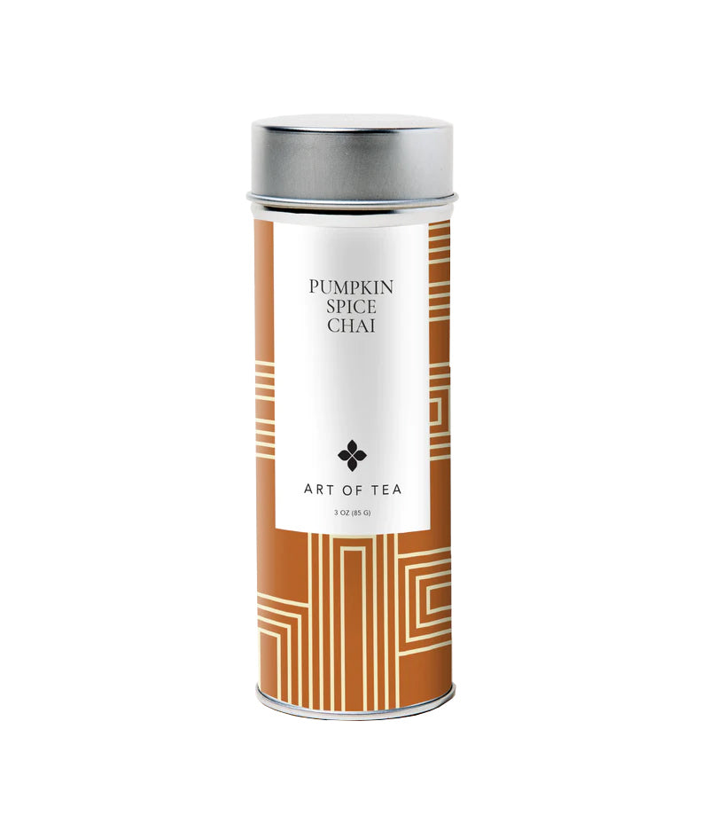 A decorative metal canister of Art of Tea branded Pumpkin Spice Chai loose leaf tea, with a beige and orange geometric design on the label.