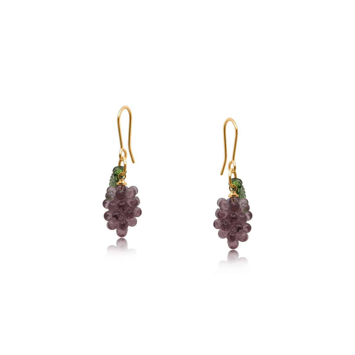 Pair of earrings with purple and green beads on a white background