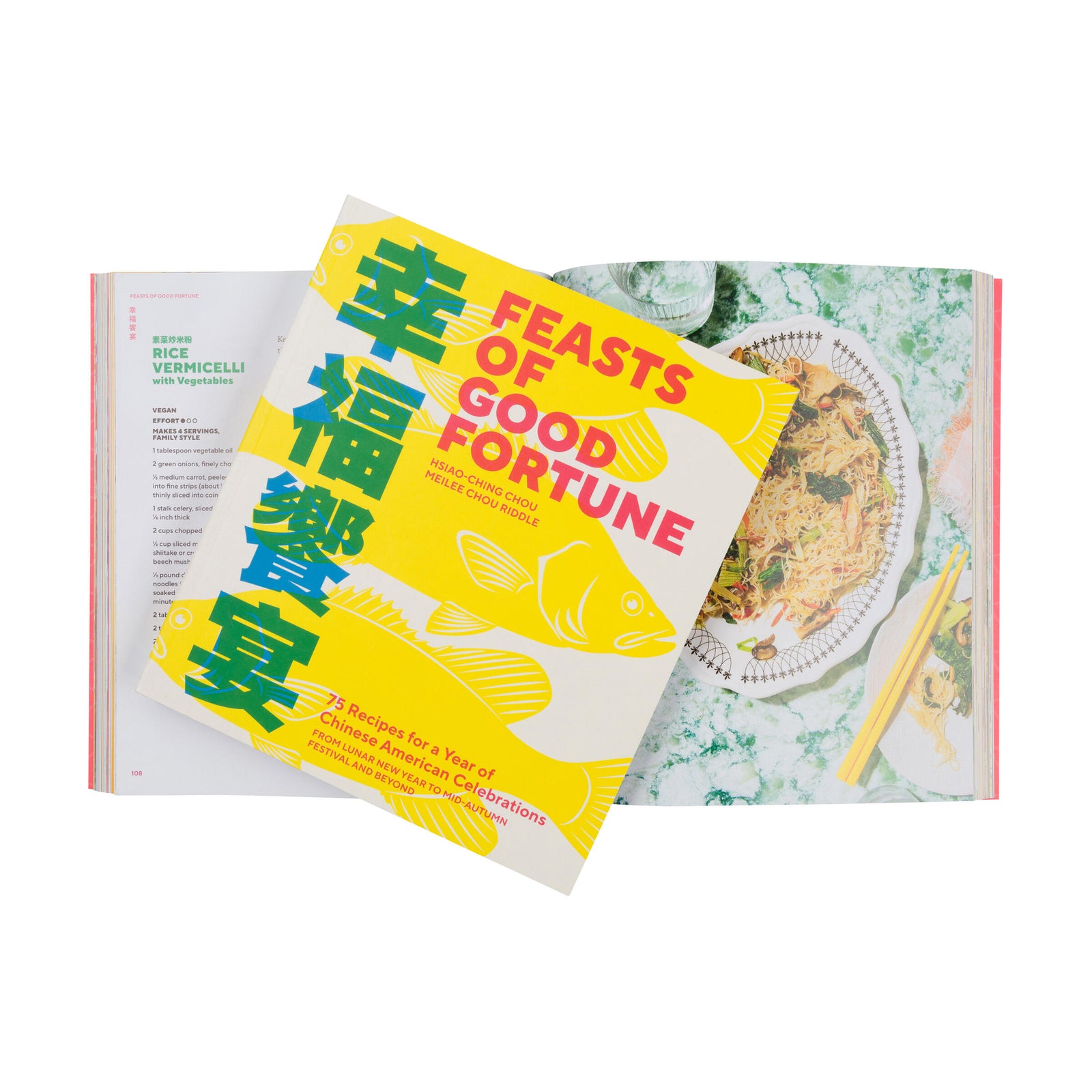 Book titled 'Feasts of Good Fortune' with a yellow cover on an open book background.