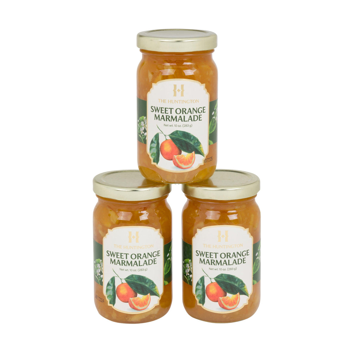 Three jars of sweet orange marmalade stacked on a white background