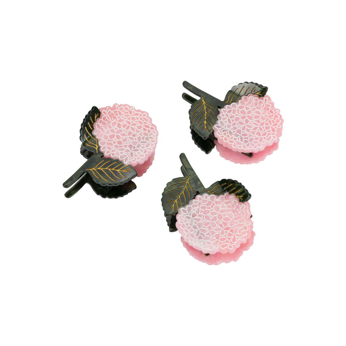 Three pink hair clips with dark green and gold accents on a white background