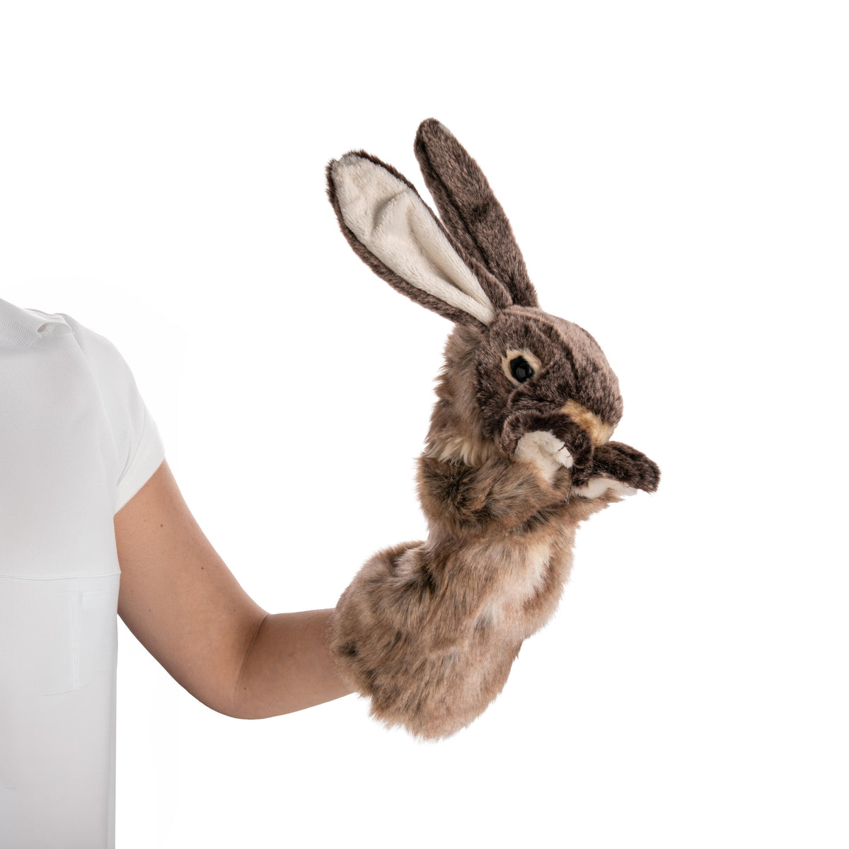 Plush rabbit toy hand puppet held by a person against a white background