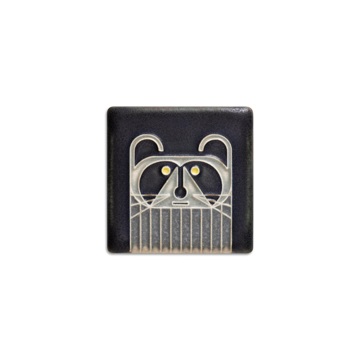 Black square ceramic tile with a raccoon design on a white background