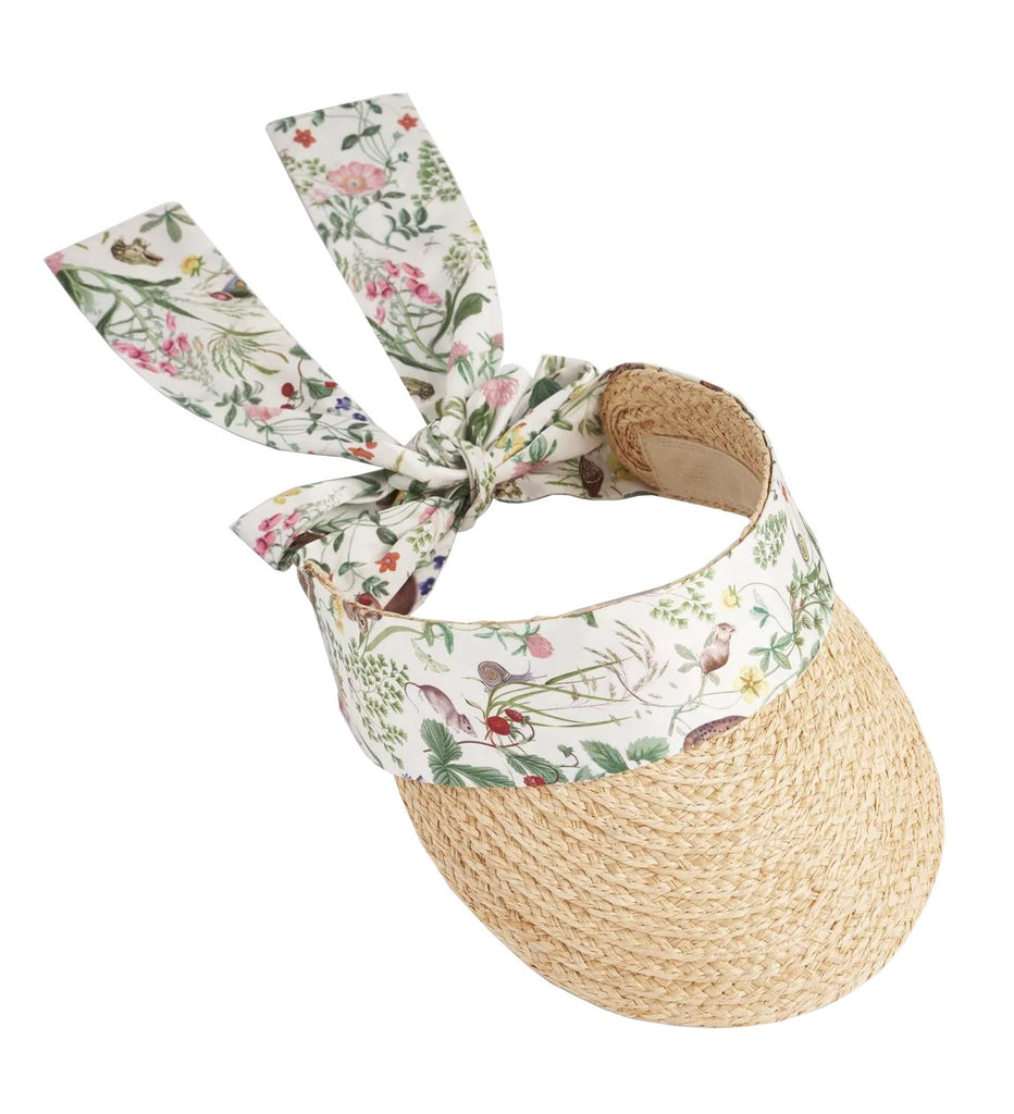 Shield your eyes from the sun on a bright, summer’s day with this natural raffia visor. Expertly crafted and accented with an ivory base, meadow print satin scarf. The scarf can be tightened or loosened as you wish for the perfect fit. Adjustable scarf tie. One size: Brim depth - 3.75". Circumference 22".