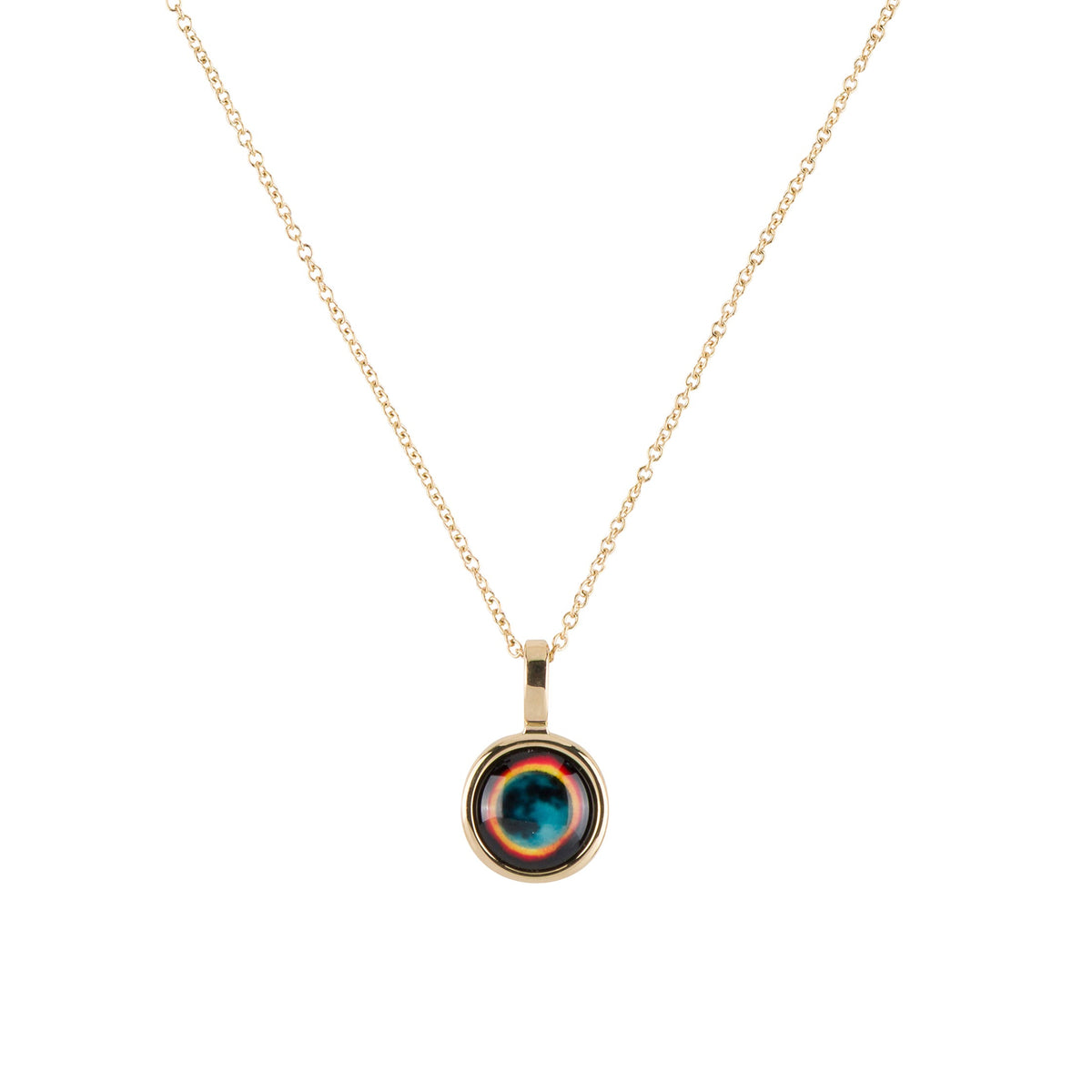 A gold chain necklace with a round bezel pendant featuring concentric rings of teal, orange, and dark brown, set against a plain white background.
