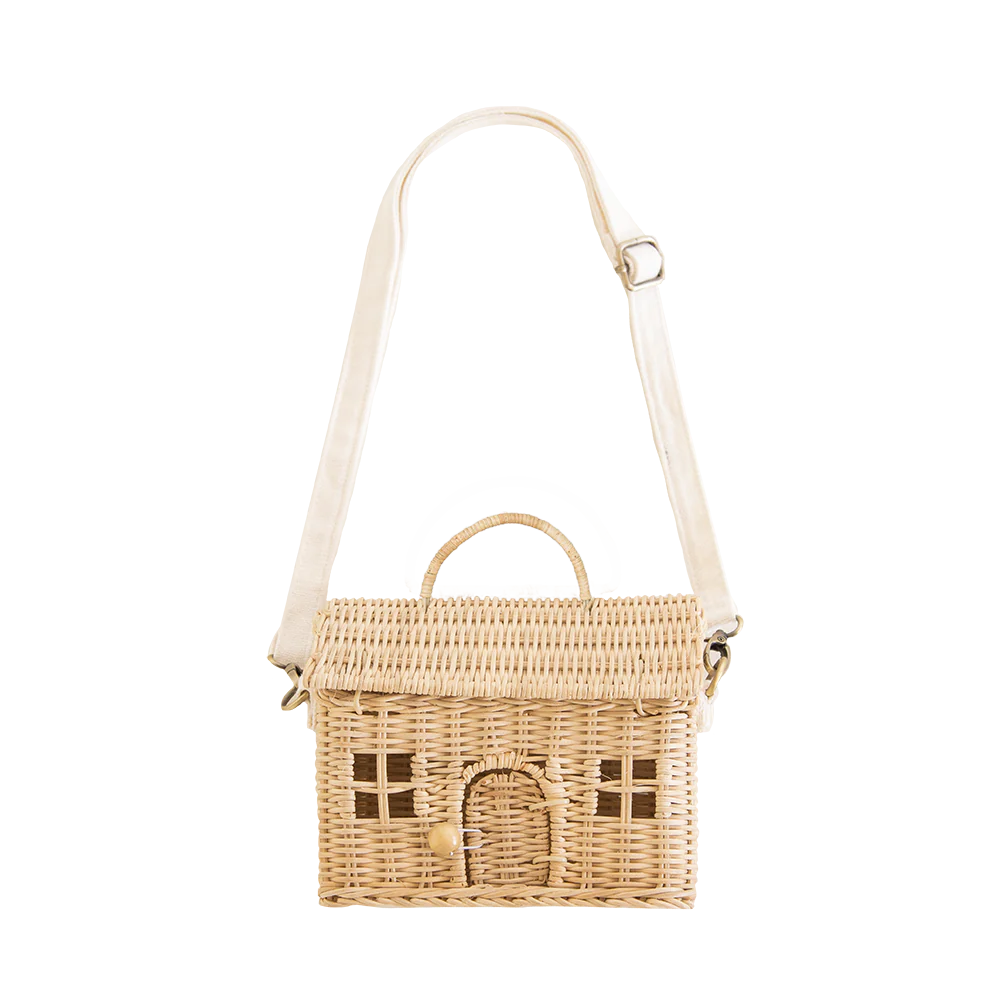 A little house-shaped rattan purse for grown-ups and kids on the go! Comes complete with a removable and adjustable fabric strap so that it can be hand-held or worn as a cross-body. Handmade from 100% natural Rattan. H 8.5” x W 7.5” x D 4”. Longest strap length: approx. 43". Shortest strap length: approx. 35".