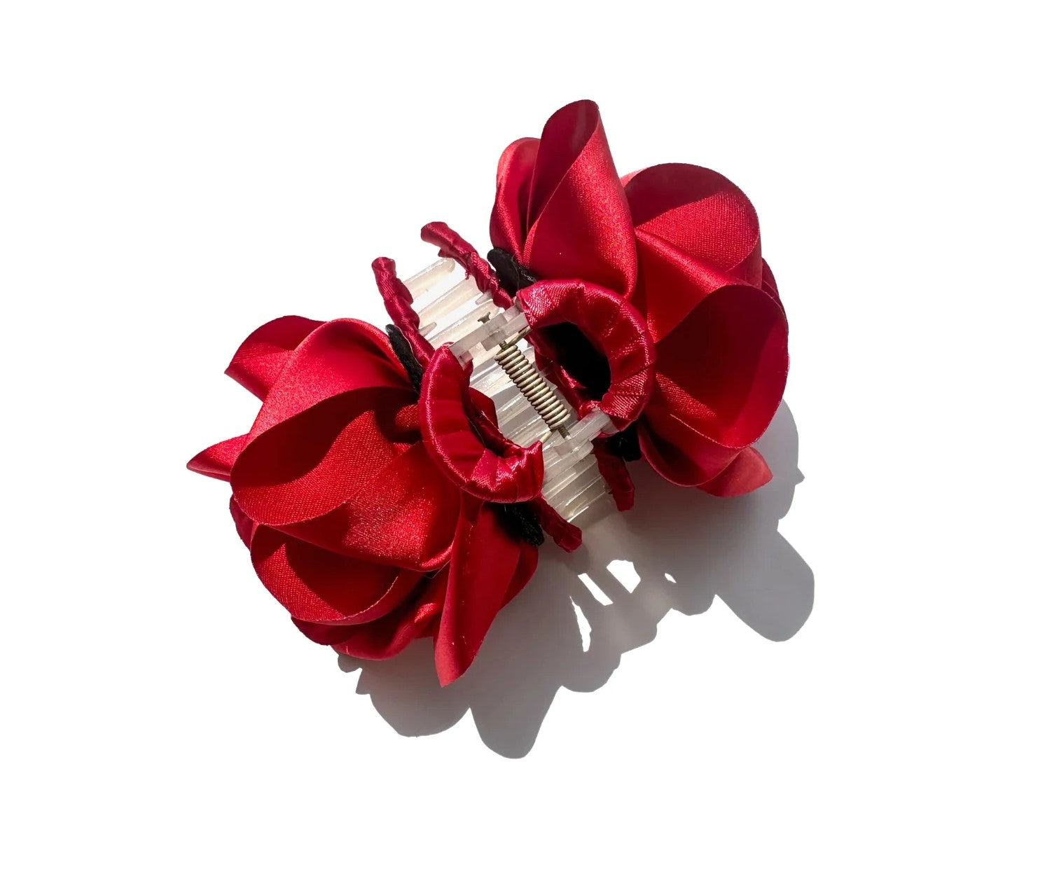 This satin rose claw hair clip is carefully made by hand. Each claw features two roses for a romantic look from all angles.