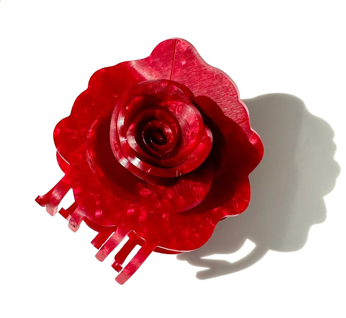 This origami rose hair clip has a layered, 3D construction, truly capturing the essence of a beautiful rose in full bloom. These unique hair clips are carefully crafted from cellulose acetate, an eco-friendly, biodegradable material made from recycled wood pulp. Dimensions: 3" x 3.5". Eco-friendly cellulose acetate.
