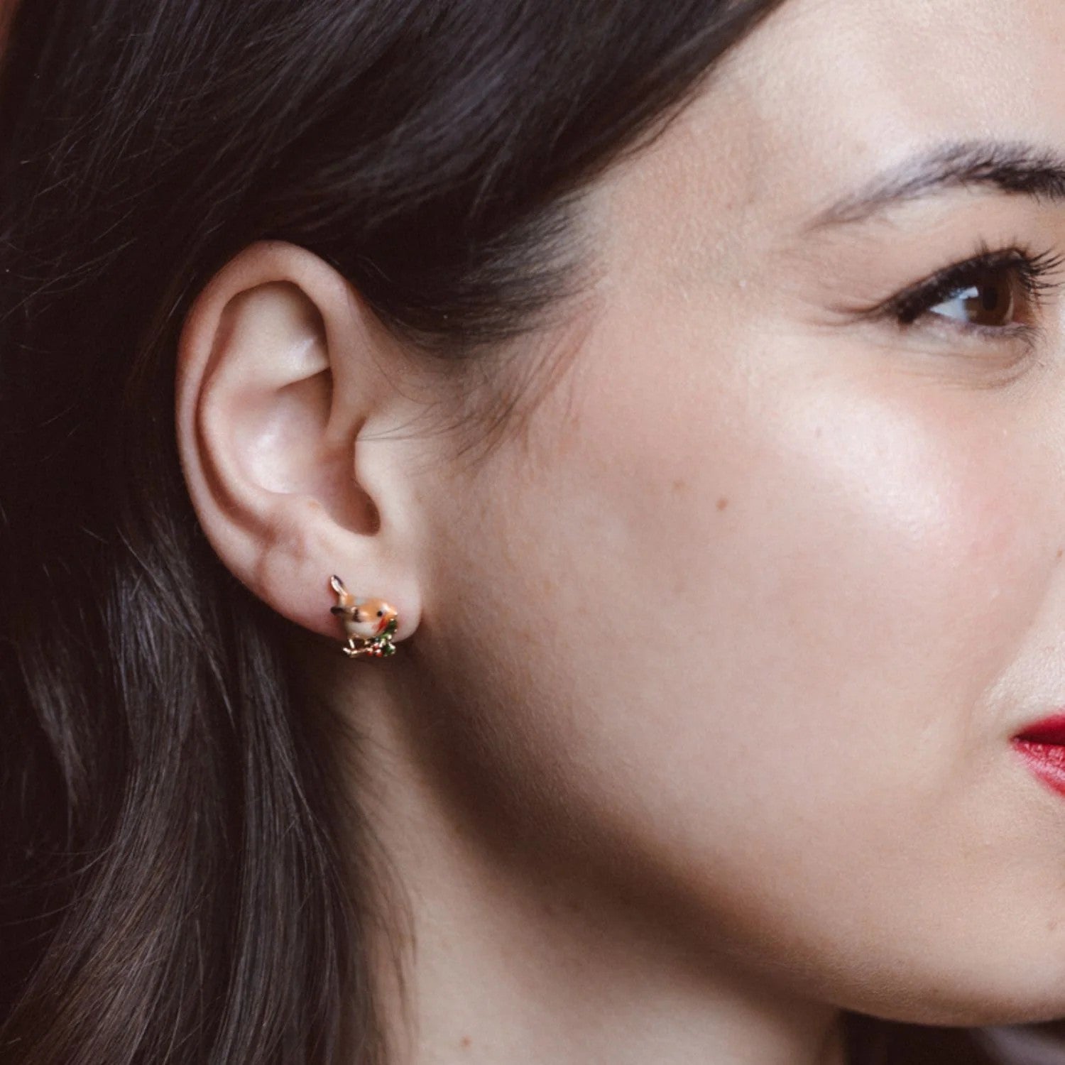 Pair of bird-shaped earrings on a white background