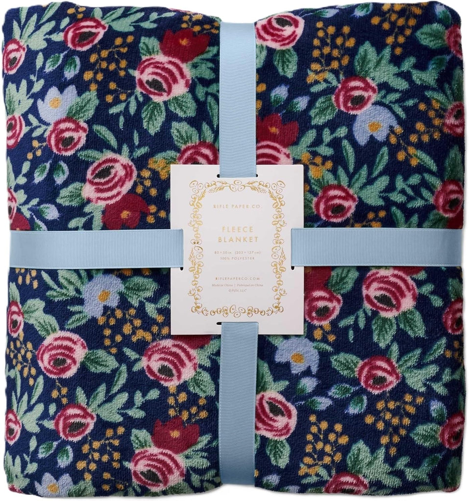 This super soft, double-sided fleece blanket is equally good for cozy nights in, and sunny picnic days outside. Featuring a pretty rose print with a deep navy base on one side, and an off-white base on the reverse. Material: 100% super-soft polyester fleece Reversible Dimensions: 80" x 50" Machine washable