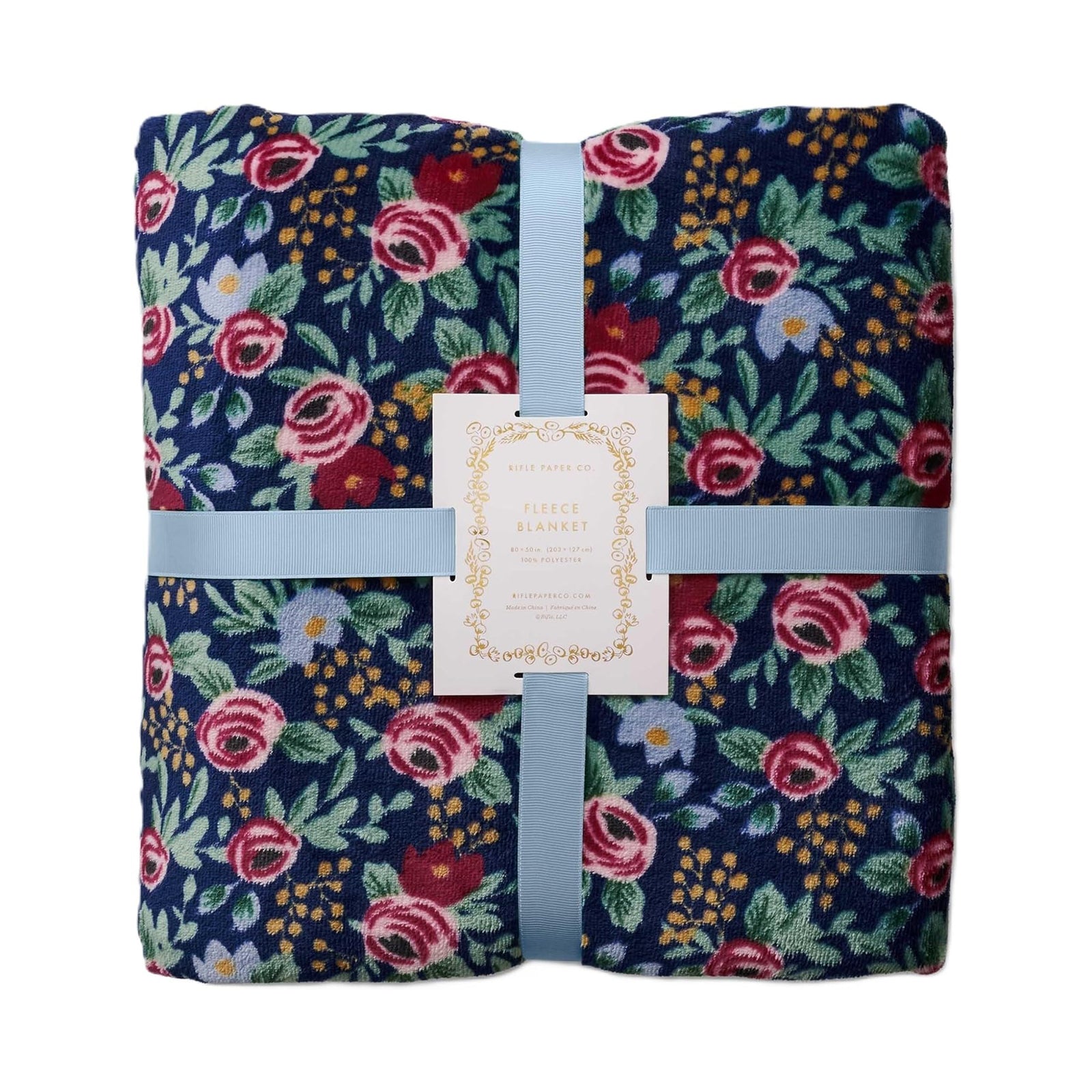 Floral-patterned blanket with a visible brand tag on a white background