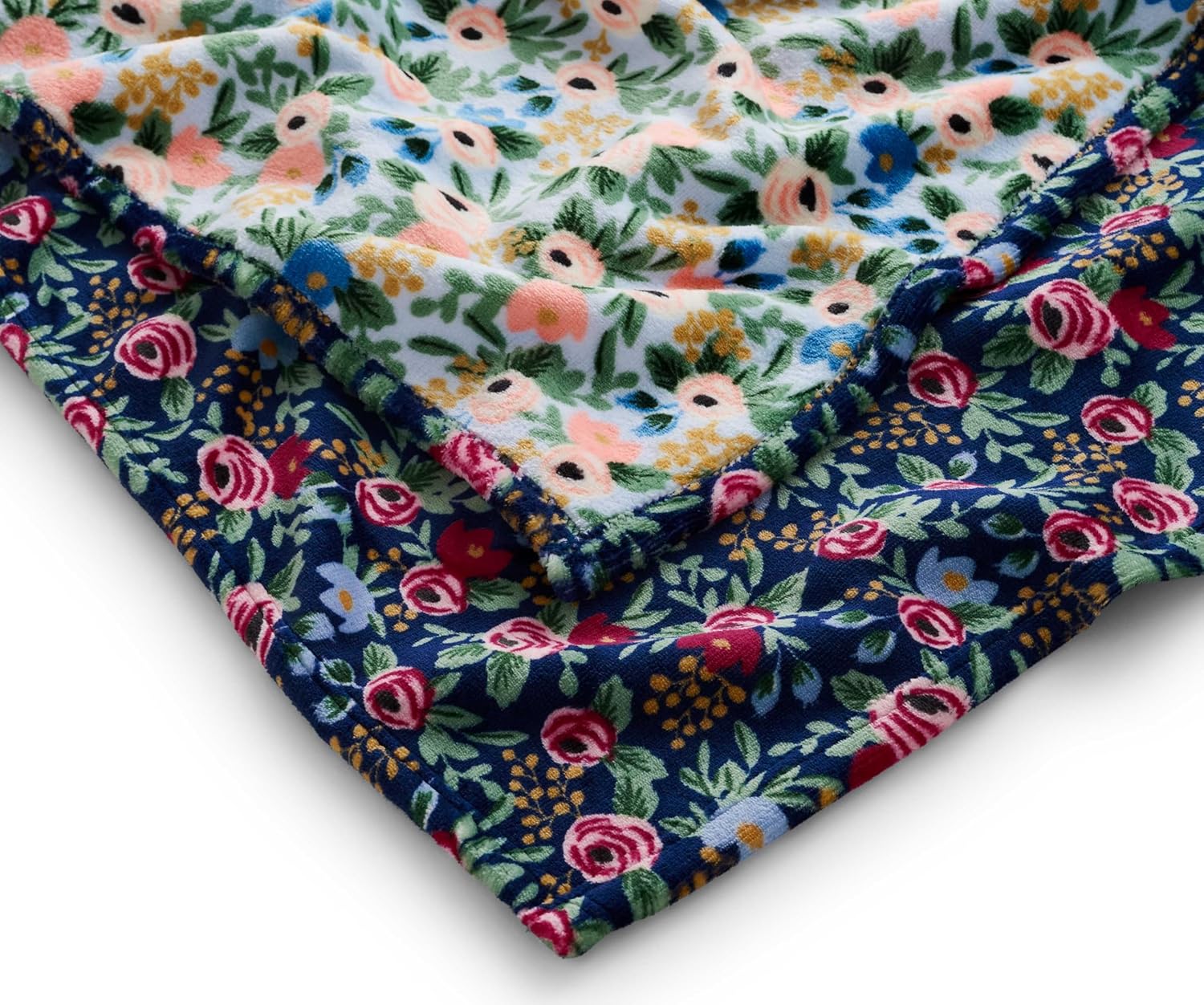 This super soft, double-sided fleece blanket is equally good for cozy nights in, and sunny picnic days outside. Featuring a pretty rose print with a deep navy base on one side, and an off-white base on the reverse. Material: 100% super-soft polyester fleece Reversible Dimensions: 80" x 50" Machine washable