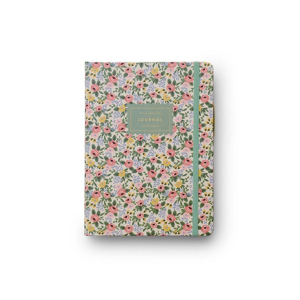 Floral patterned journal with a green ribbon on a white background