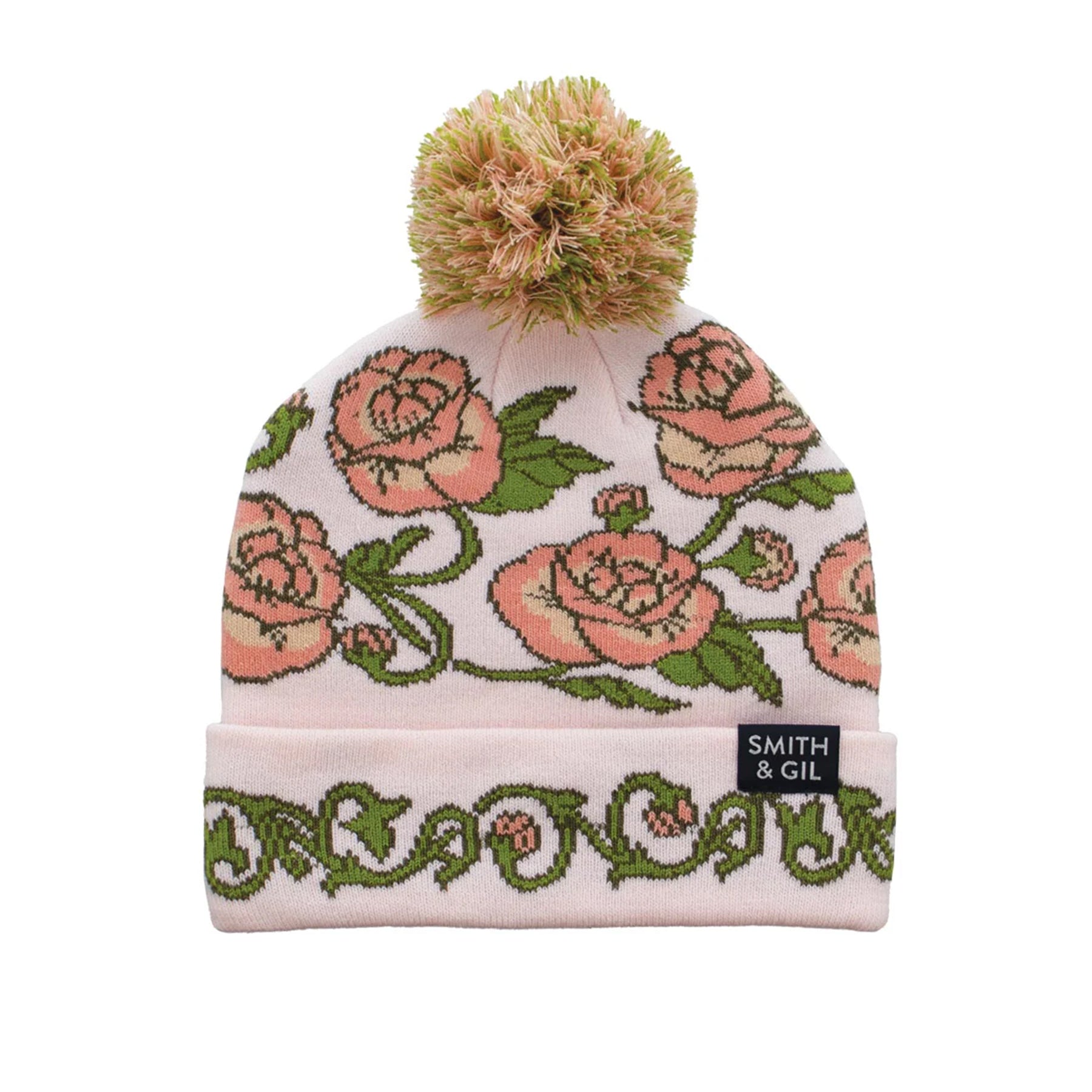 Pink rose floral patterned beanie with pom-pom on a white background