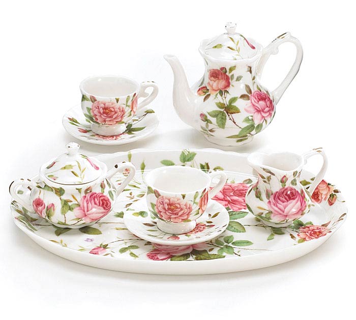 This detailed miniature tea set features a pink rose design with hand-painted gold accents. The set contains a porcelain tea set with tray, teapot, 2 teacups and saucers, sugar and creamer set. The perfect set for your next teddy-bear picnic. Overall dimensions: 4"H X 9"W X 6"D. Presented in a satin-lined gift box.