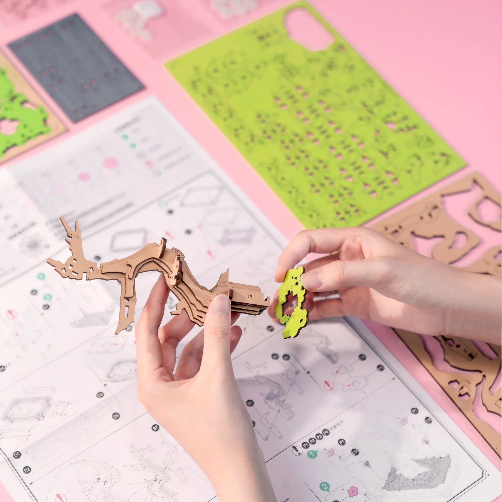 Bonsai tree with pink and white flowers in a wooden pot on a white background