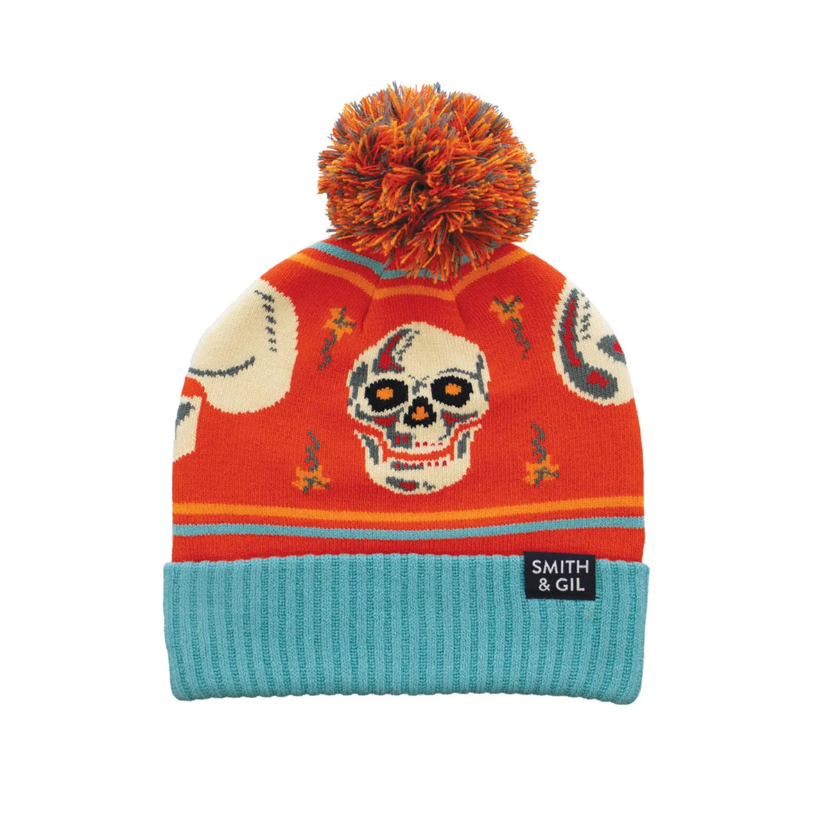 Colorful knit beanie with skull design and orange pom-pom on a white background