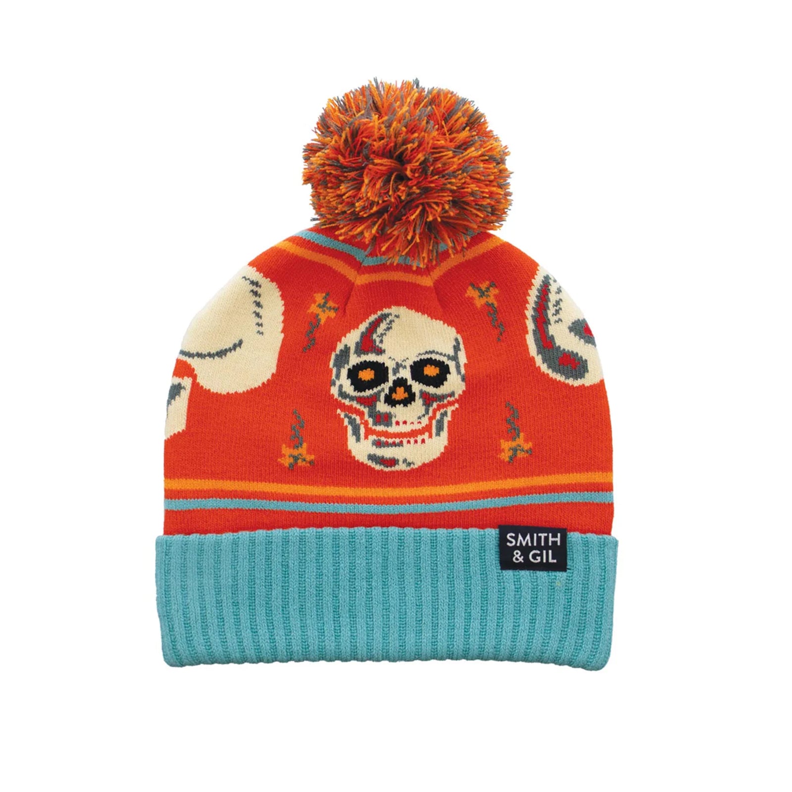 Colorful knit beanie with skull design and orange pom-pom on a white background