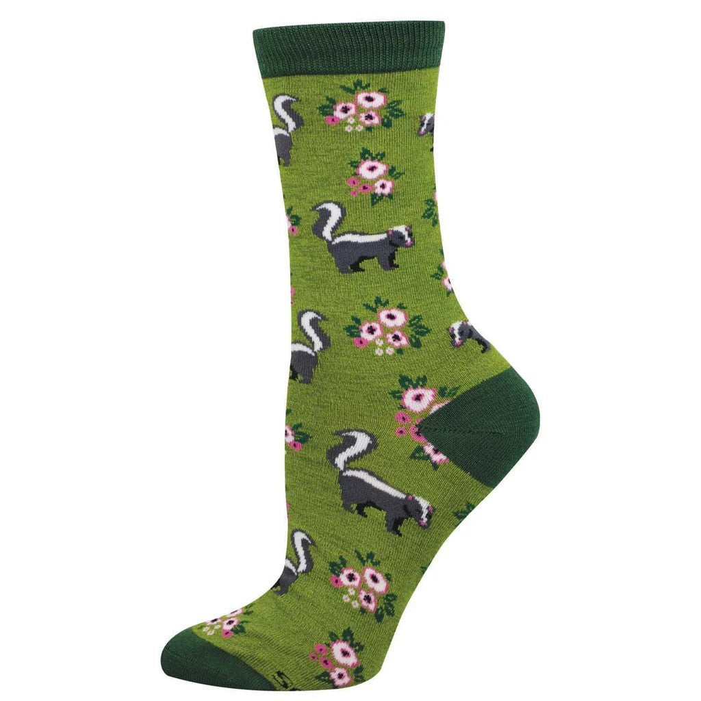 Green sock with skunk and flower pattern on a white background