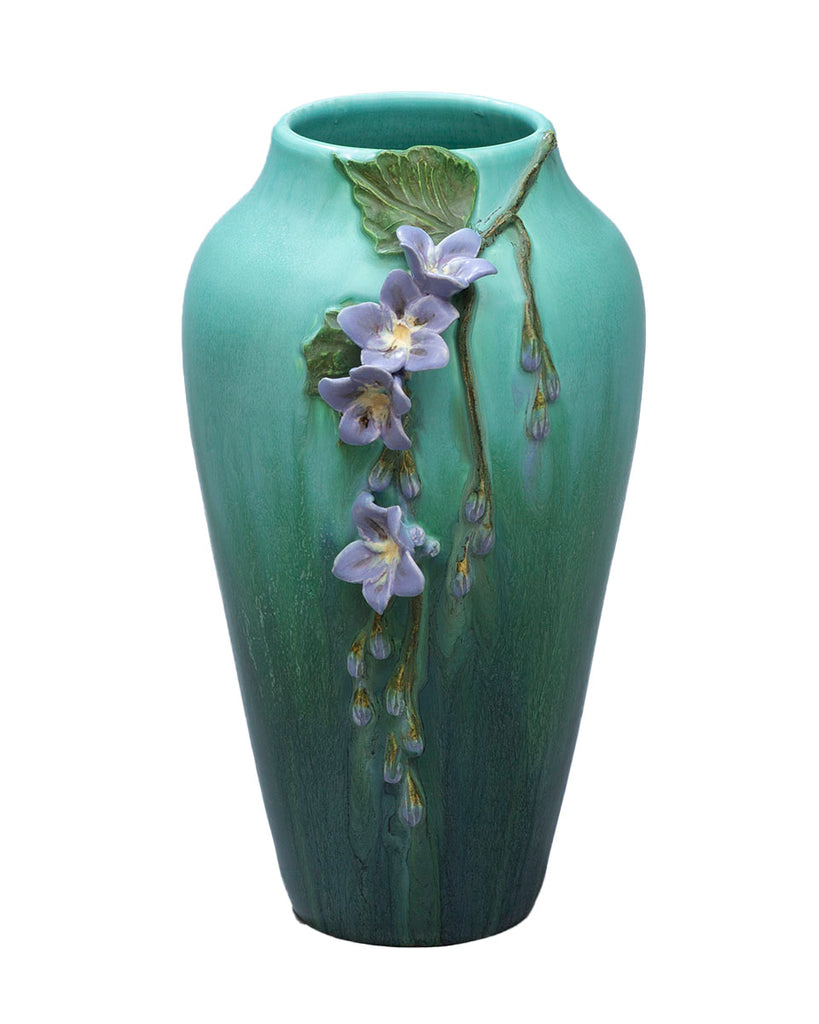 The vibrant Skyflower, with its beautiful drape and bright blue color blossoms, inspired this striking, hand-sculpted vessel. The skyflower is widely cultivated by Central and South American gardeners for its floral clusters that bloom to attract butterflies and hummingbirds year round. Size approx. 10.5" x 6.5".