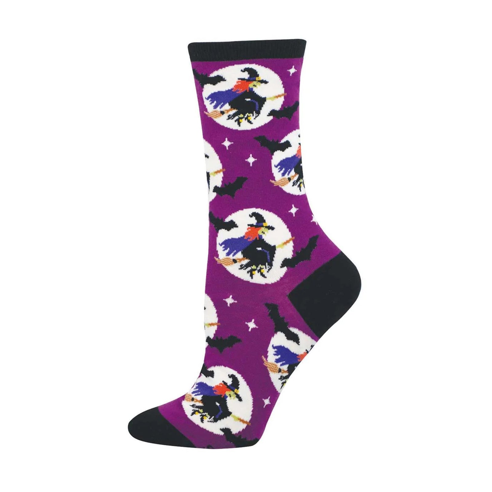 A pair of purple crew socks with a Halloween-themed pattern featuring witches on broomsticks, crows, bats, and stars, with black heels, toes, and cuffs.