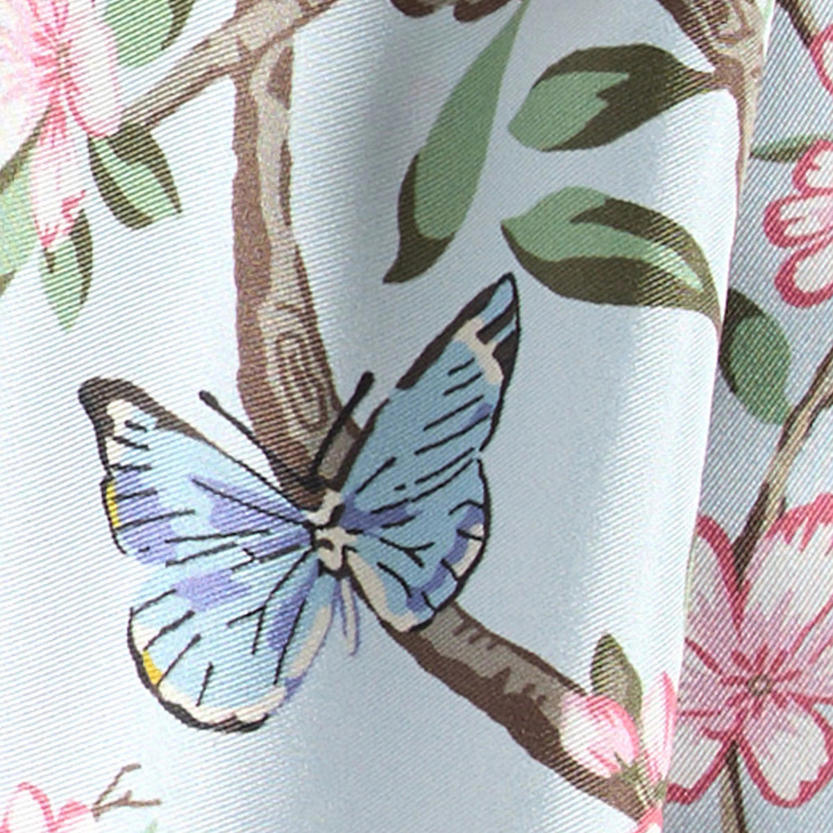 Close-up of a fabric with a butterfly and floral pattern