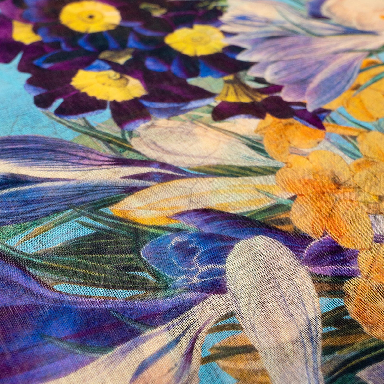 Woman wearing a colorful floral-patterned scarf on a white background