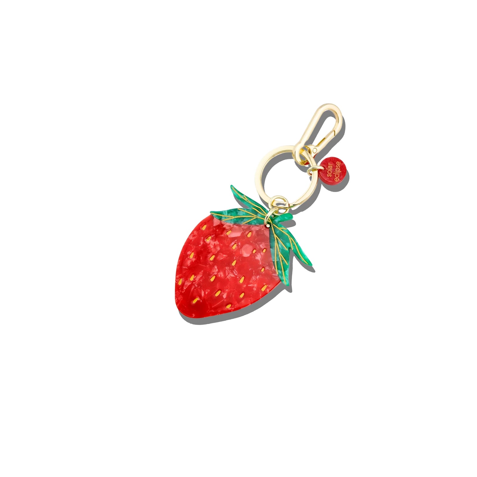 Strawberry-shaped keychain with gold clasp on a white background
