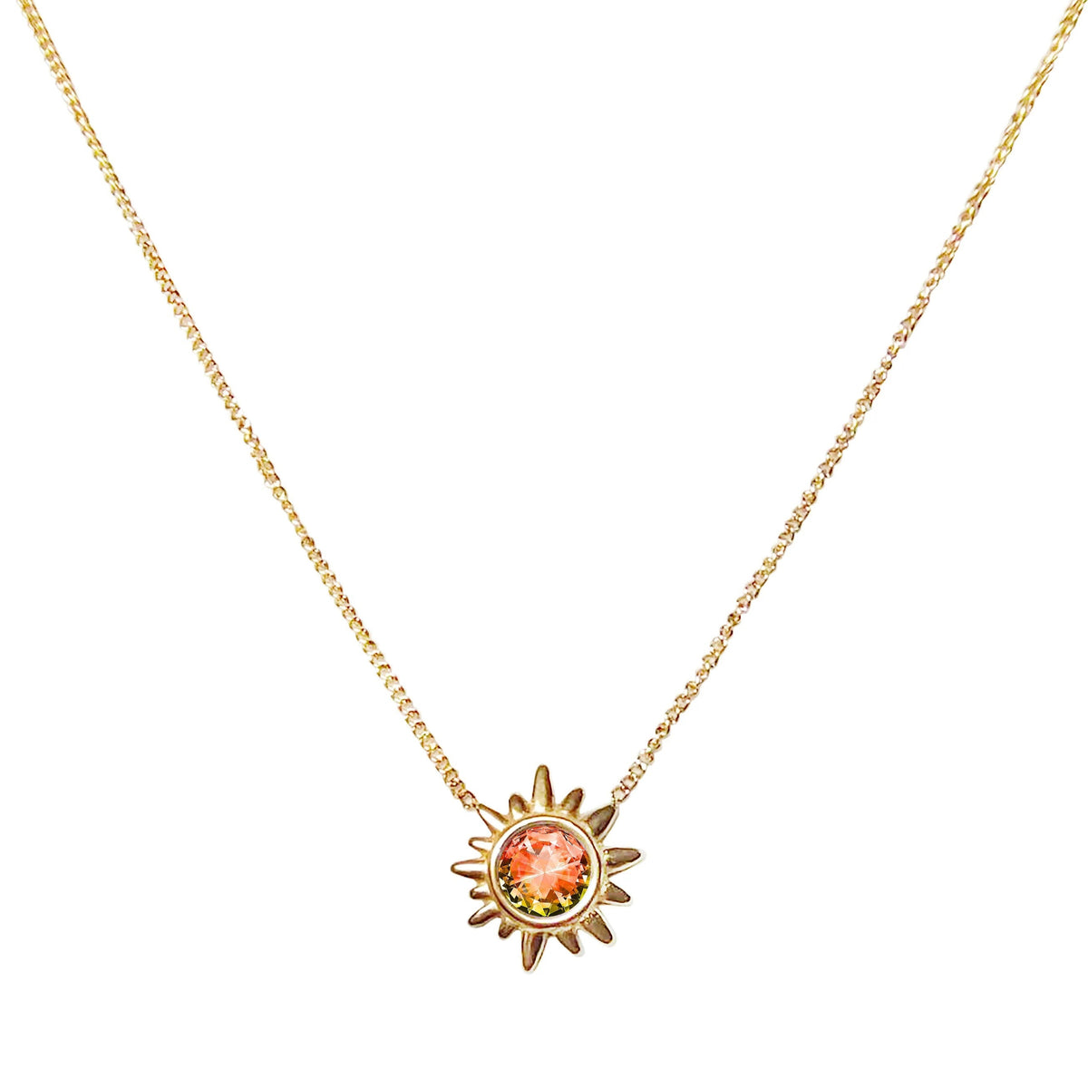 Gold necklace with a sun-shaped pendant on a white background