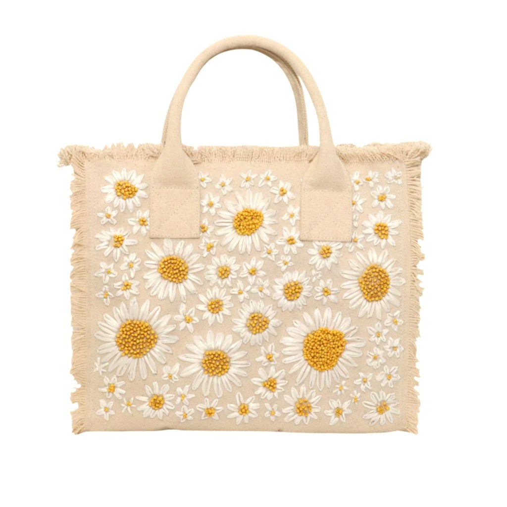 Beige tote bag with white daisy pattern on a white background