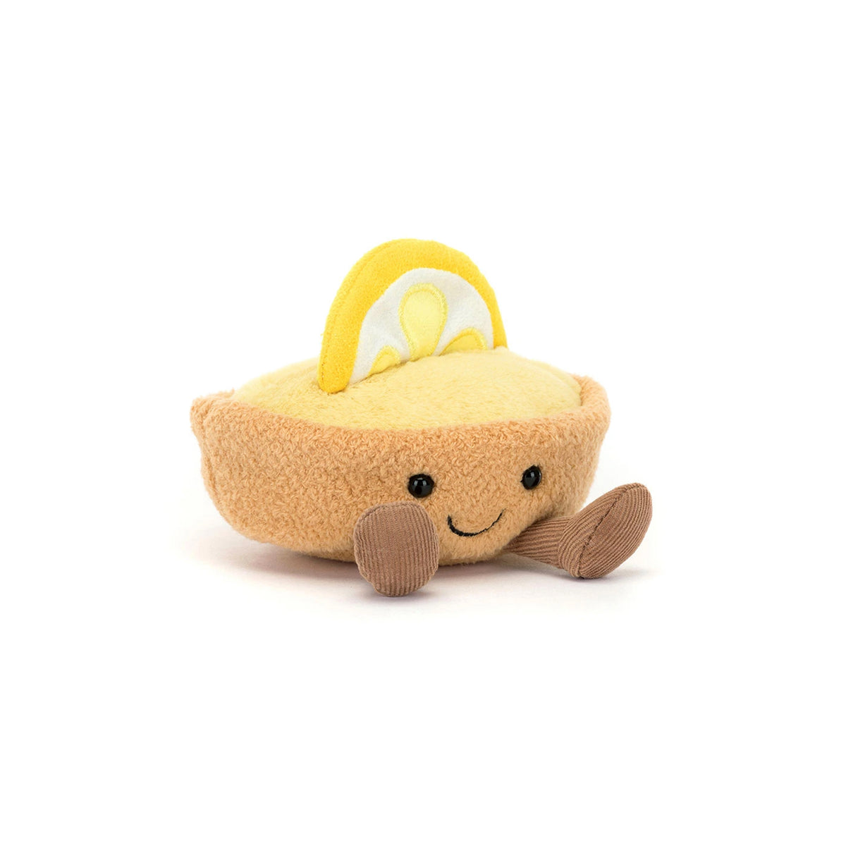 A cute plush toy Jellycat Amuseables Colette Tarte Au Citron, shaped like a lemon tart, featuring a yellow textured body, a brown crust, a yellow lemon slice on top, and a smiling face with brown corduroy legs, set against a plain white background.