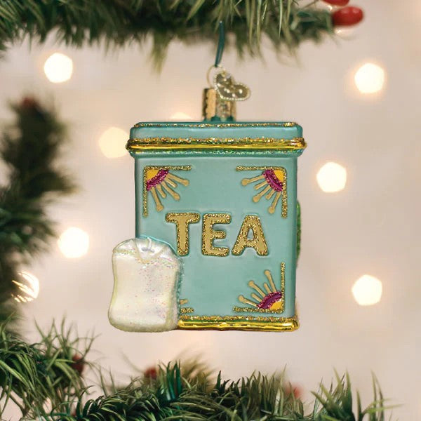This delightfully sparkly vintage style tea-tin ornament is perfect for any tea enthusiast.   With hand-glittered details, including a miniature tagged tea bag! Hand finished, glass ornament. Dimensions: 2.5" x 2".