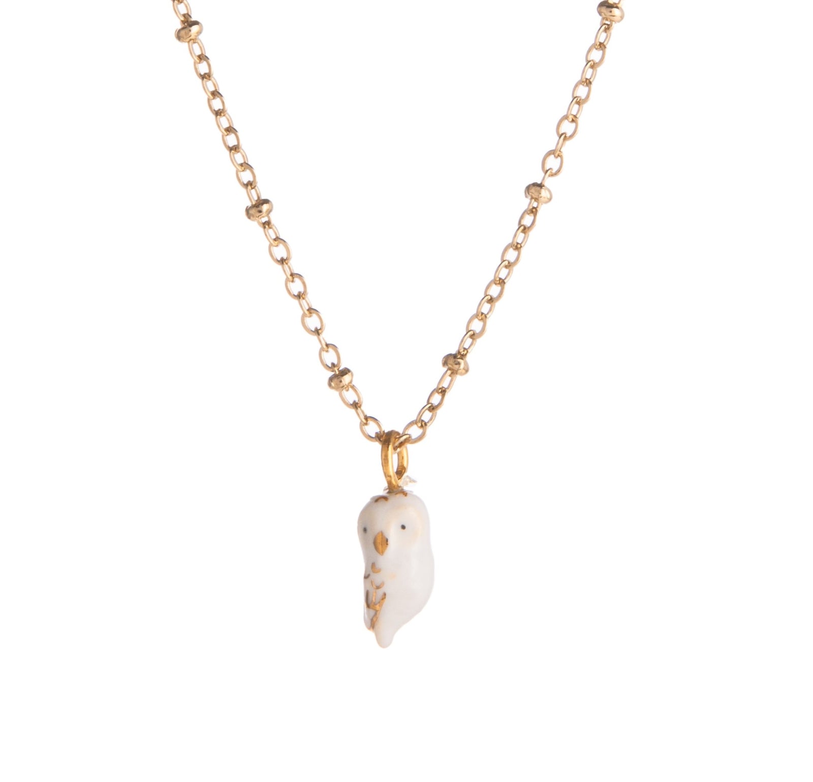 We love this teeny tiny owl featured on a gold chain necklace. Hand-painted with gold detail, this sweet little owl adds a delicate touch of nature to your outfit. This makes the perfect gift for any owl lover or bird watcher. Lead and Nickel-free Material: Porcelain, Gold-plated Brass Designed in Toulouse, France