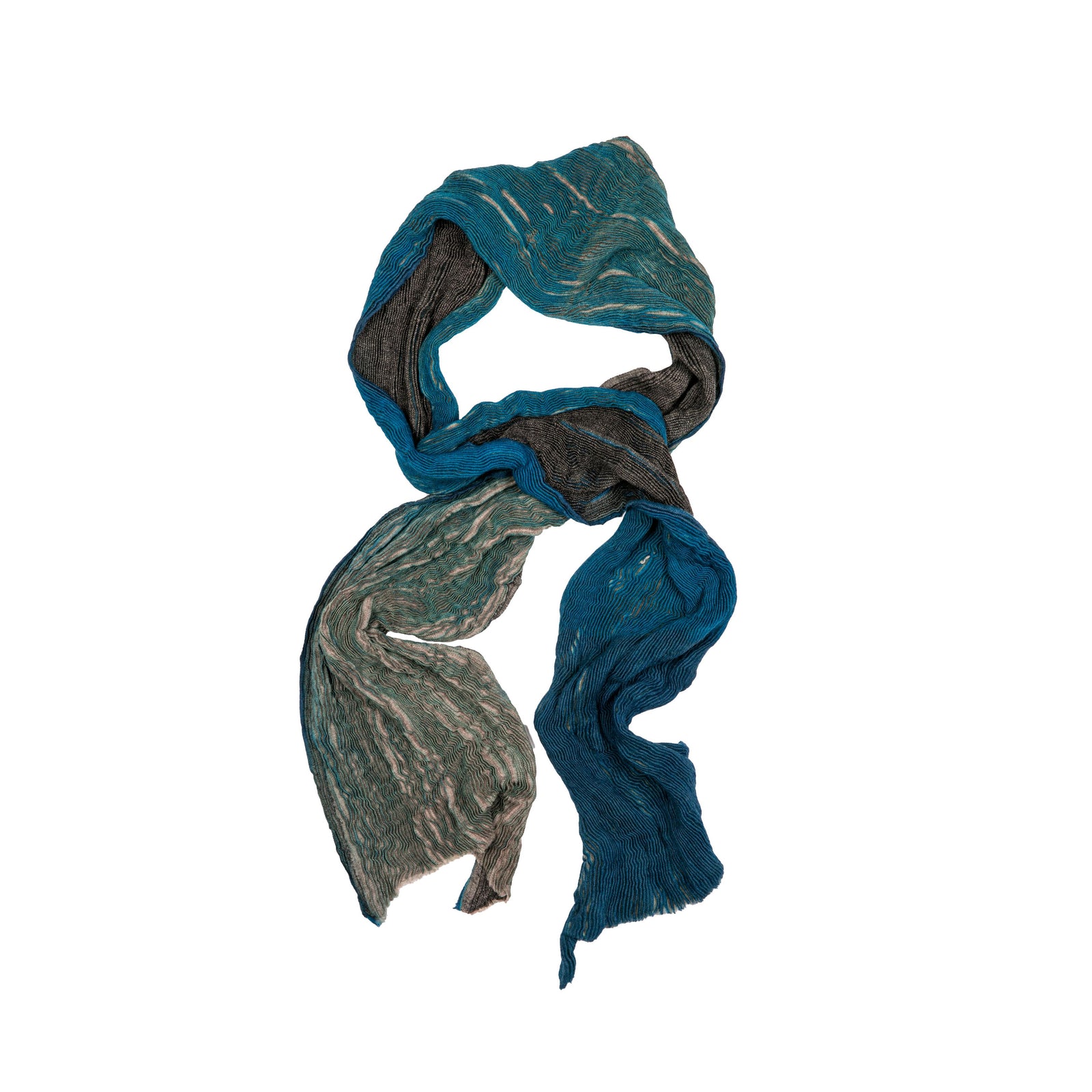 This striking 100% wool scarf is made using the shibori dyeing technique. This technique produces multitone patterns on fabric and is similar to yet more intricate than tie-dyeing.  Each scarf is individually dyed by hand. 100% wool scarf Shibori dyed, so each scarf is unique (scarves may vary slightly from the photos) Dimensions: 78.5" x 27.5"