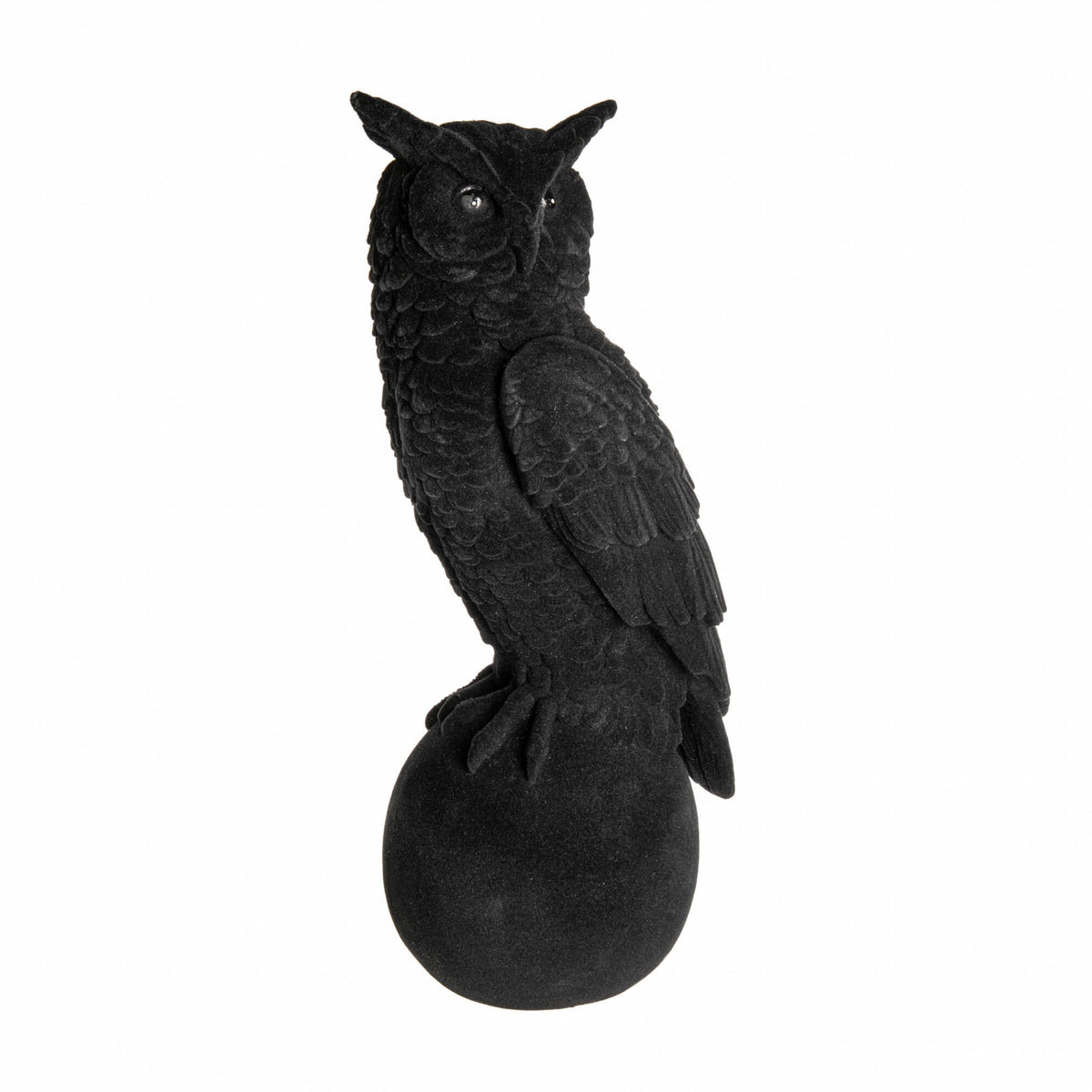 Black owl figurine on a white background