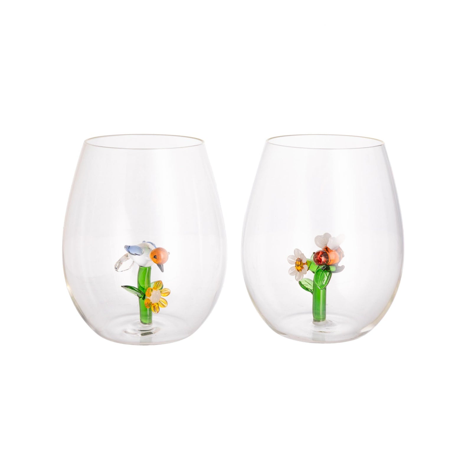 Two clear stemless wine glasses with decorative elements on a white background