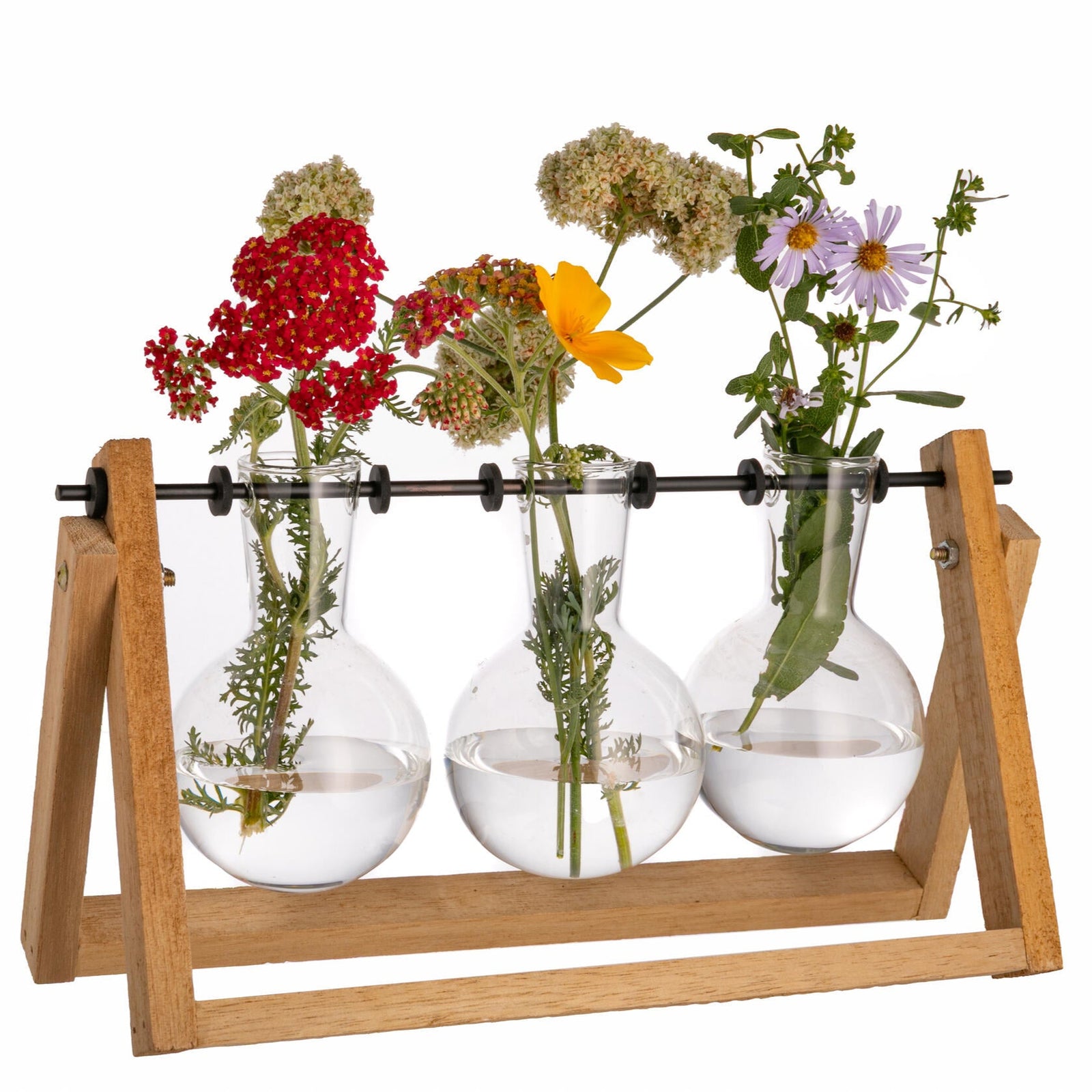 Floral arrangement in glass vases on a wooden stand with a white background