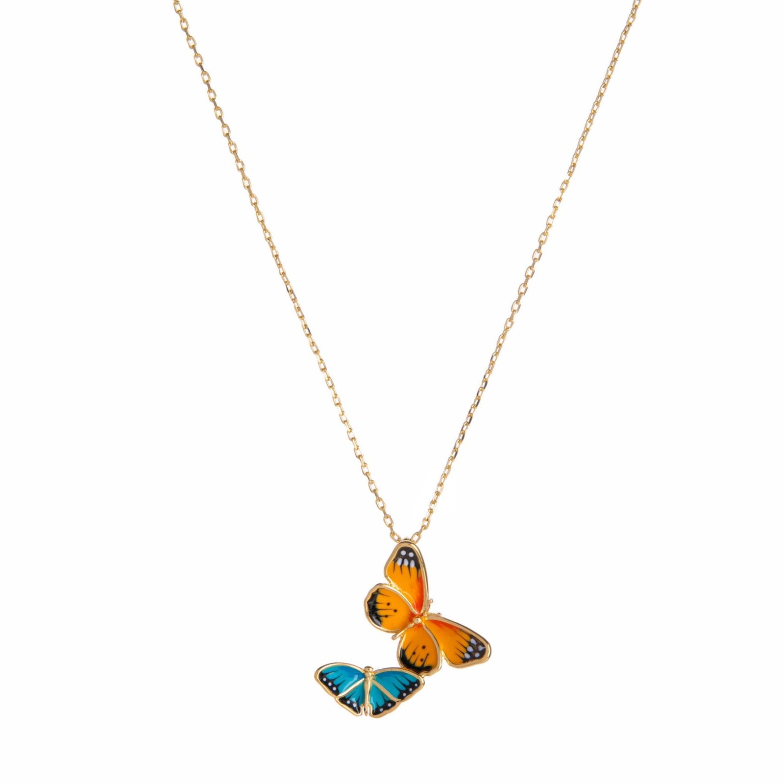 Butterfly-shaped pendant on a gold chain against a white background