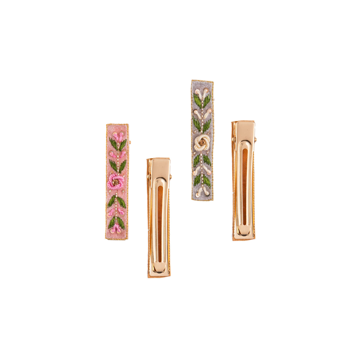 Set of four floral hair clips on a white background