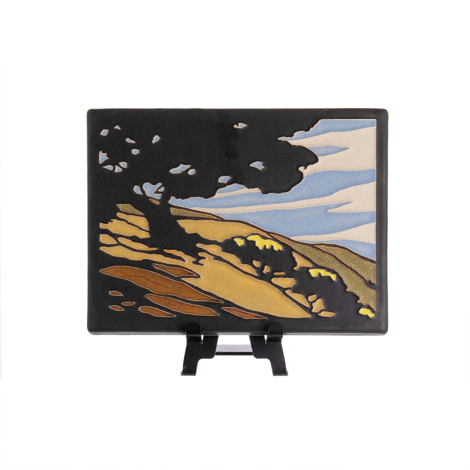 Artist Yoshiko Yamamoto is a self-taught block printmaker who fuses Japanese design sensibility with fine craftsmanship. "California Oak" tile is inspired by the rolling hills of the Central Coast in California. 5 7/8” x 7 7/8”. Motawi tiles are handcrafted. Notch at the back for hanging. Tile stand sold separately.