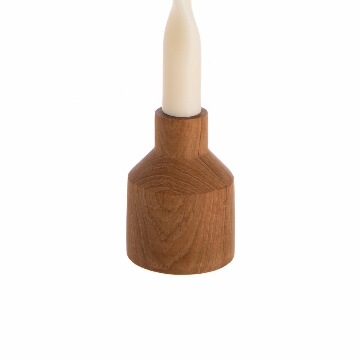 Wooden candle holder with a white candle on a white background
