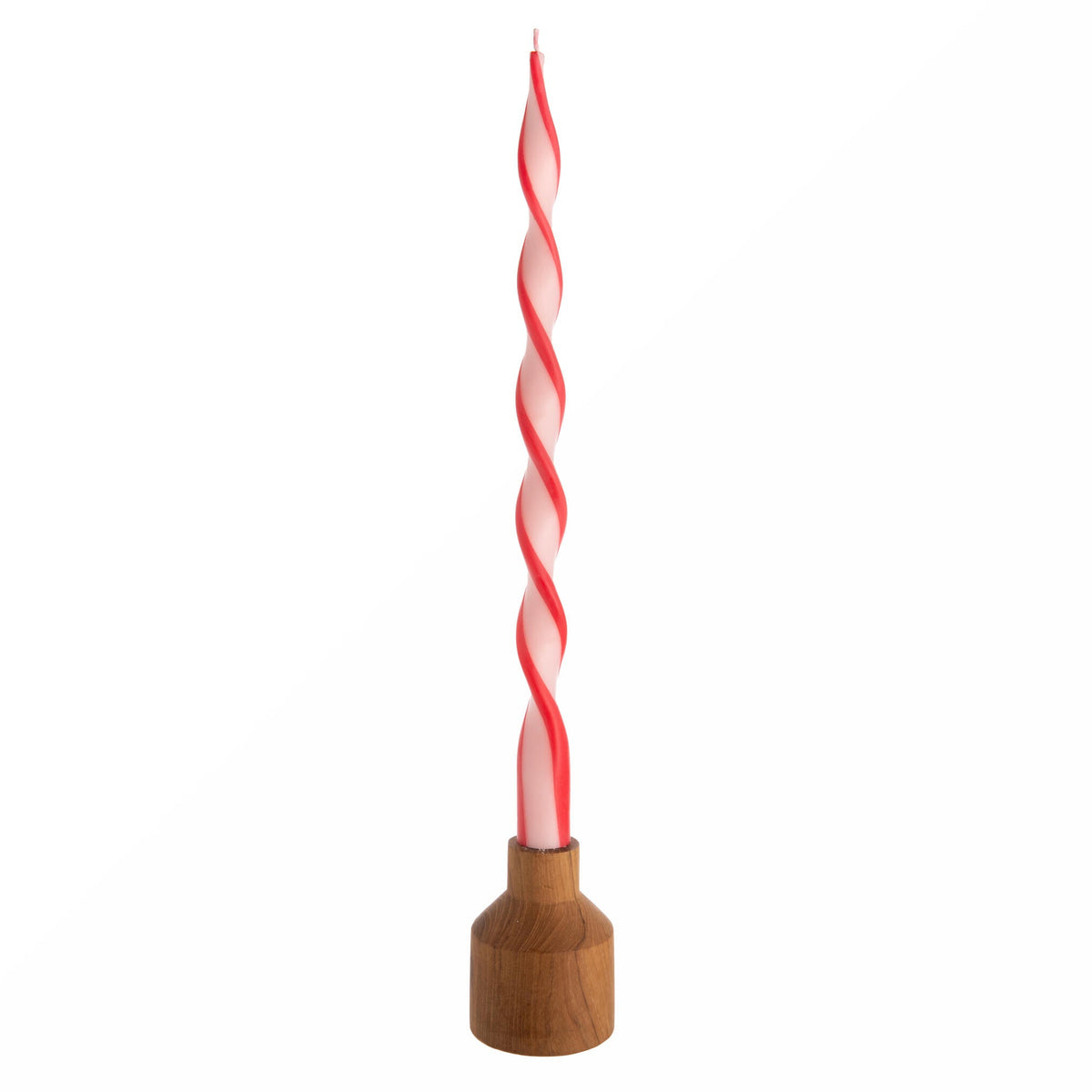 Twisted red and white candle with wooden base on a white background