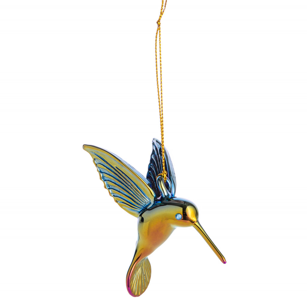 The Hummingbird is one of California's most beloved feathered friends, with its colorful feathers and sweet buzzing sound, it's a welcome sight in any garden. Celebrate this magical bird with this handmade glass ornament. Features a rainbow chromatic finish, which changes color as it turns. Dimensions: 3.5" x 2.25".